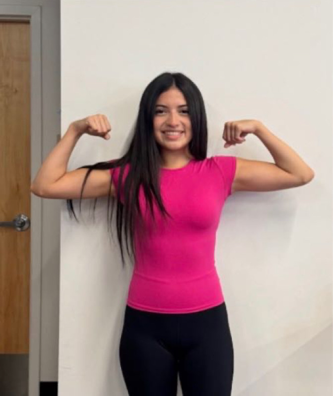 Kassandra flexing both arms